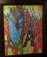 Multicoloured painting showing triangular shapes that are reminiscent of houses or statues.