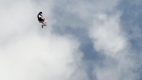 person falling through a cloud-filled sky 