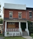 This red brick house with a covered front porch is located in the Lowertown West Heritage Conservation District.
