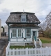 Old wooden house with a picket fence in front located at 306 Cyr Avenue.