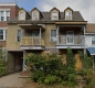 Abandoned historic side-by-side duplex with boarded up ground floor windows at 227-229 St. Patrick Street.