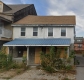 Abandoned historic house with boarded up ground floor windows at 231-233 St. Patrick Street.