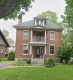 Historic two-storey brick house with porch at 501 Cole Avenue.