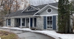 Front façade of modern stone house at 125 Lakeway Drive.