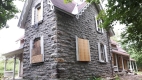 This 19th century stone farmhouse is located at 173 Huntmar Road. It features decorative woodwork and porches.