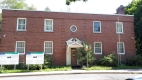 This flat-roofed two storey red brick building is located at 231 Cobourg Street in Sandy Hill.