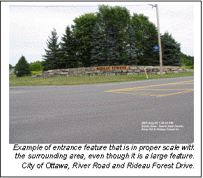 Text Box:   Example of entrance feature that is in proper scale with the surrounding area, even though it is a large feature.  
City of Ottawa, River Road and Rideau Forest Drive.  
