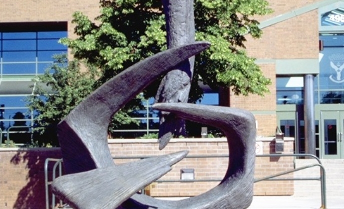 Bronze sculpture of a phoenix rising out of a talon grasp.
