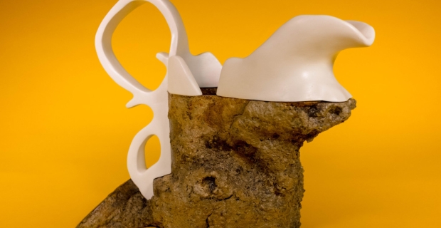 A mixed media sculpture in the shape of a jug.