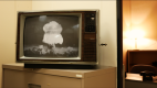 old black and white television with an image of a mushroom cloud