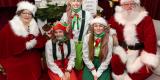 Santa Claus and Mrs. Claus with elves