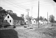Black and white image of several partially built homes. 