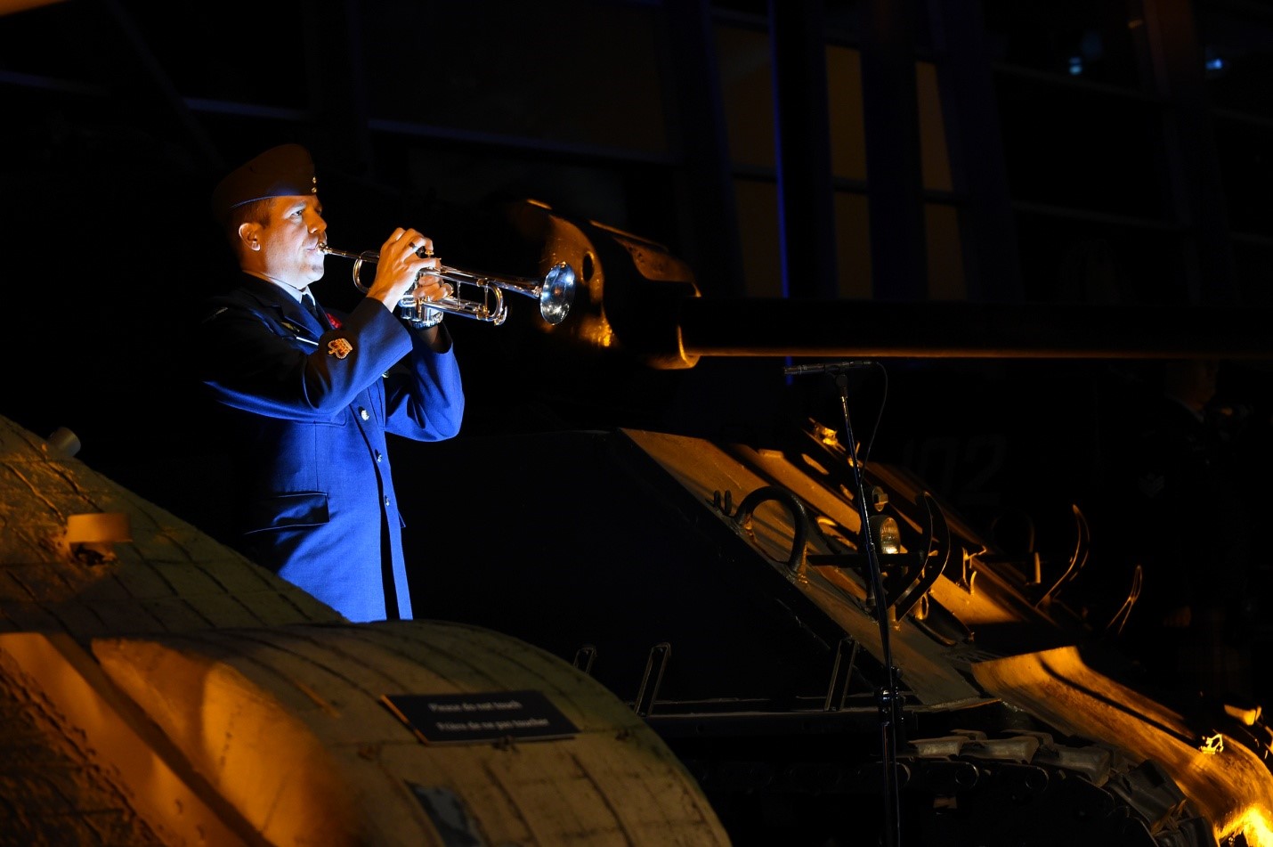 Military person playing bugle 