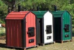 Three unconnected hydronic heaters / outdoor woodburning boilers in various colours