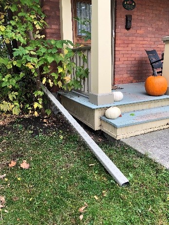 A properly installed downspout in front of a house.