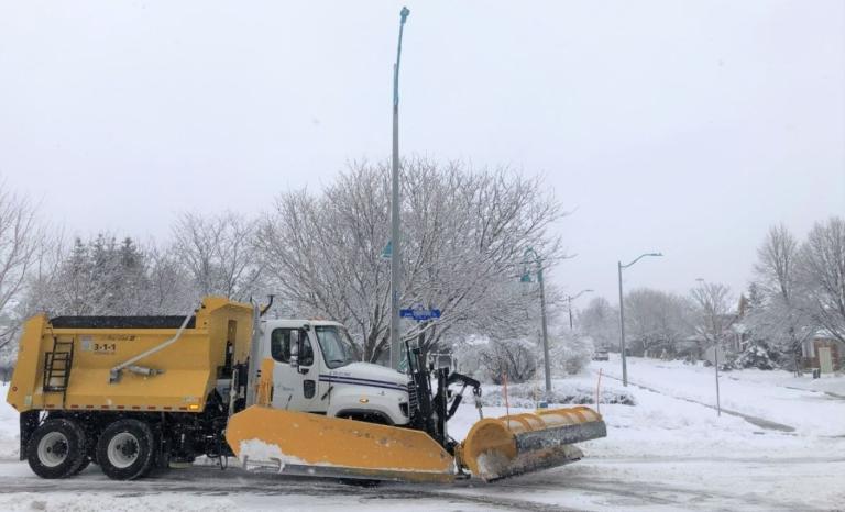 Picture of a snow plow on a snow covered roadway