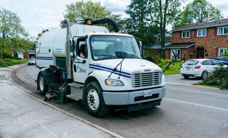 A street sweeping machine cleaning the road