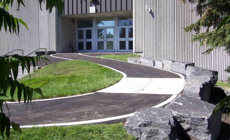 Wheelchair accessible ramp leading to office entry door