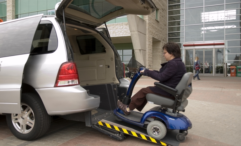 Young person in wheelchair entering Para Transpo van