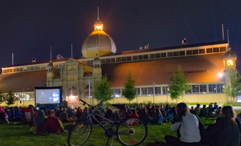 crowd of people watching a movie outdoors
