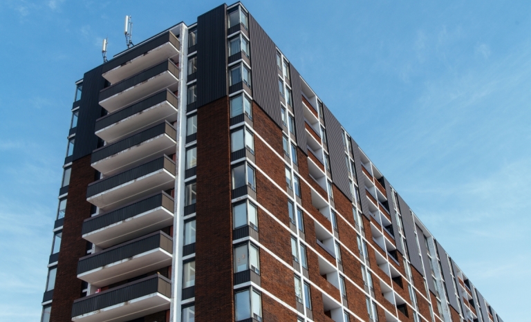 Looking up at a highrise building against the sky