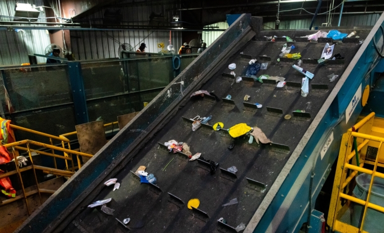 A conveyor belt at a recycling sorting facility