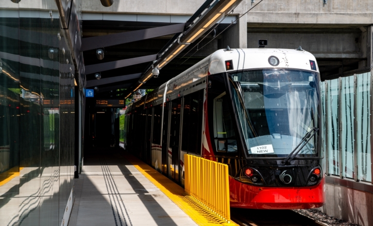 An LRT train parked at a station viewed from the platform