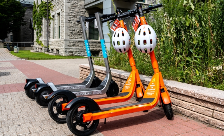 Four e-scooters parked at City Hall