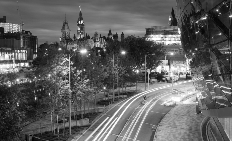 A night time shot of downtown with the Shaw Centre, The Rideau Canal and the Parliament Buildings