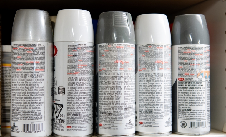 A box of five spray paint cans