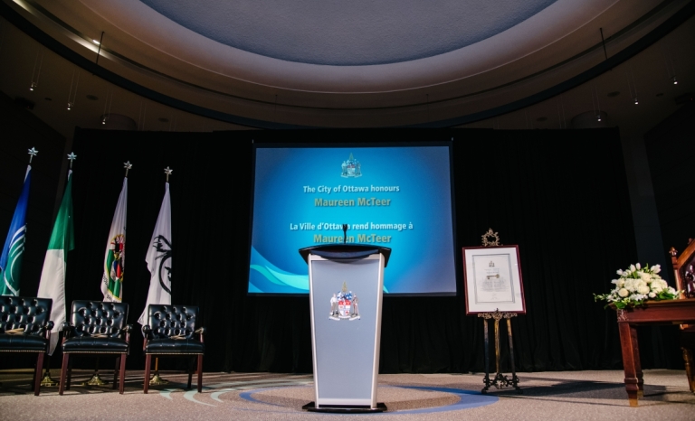 The center of City of Ottawa Council Chambers with the awards ceremony set up for a Key to the City event for Maureen McTeer.