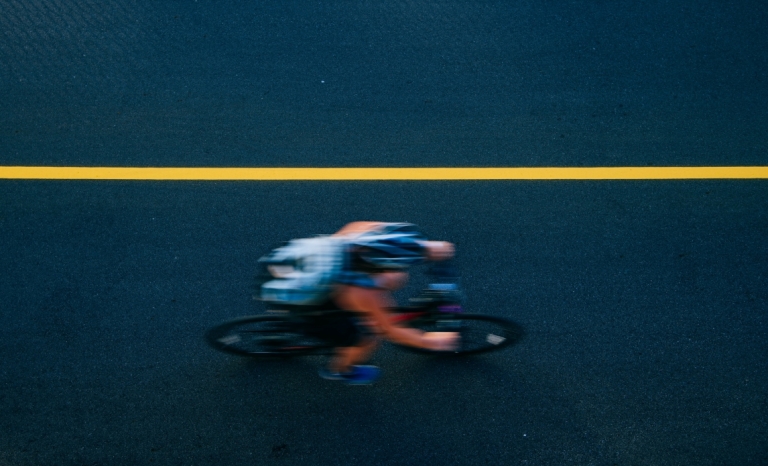 An overhead view of a blurry speeding cyclist on a new bike path