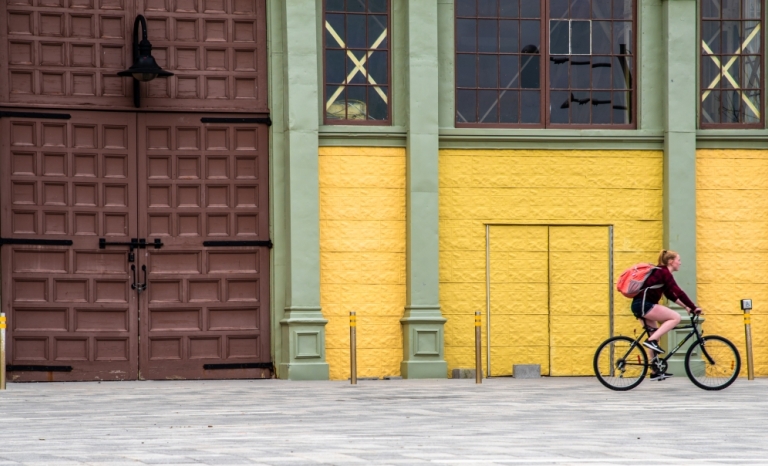 A cyclist riding in front of Aberdeen Pavillion at Lansdowne