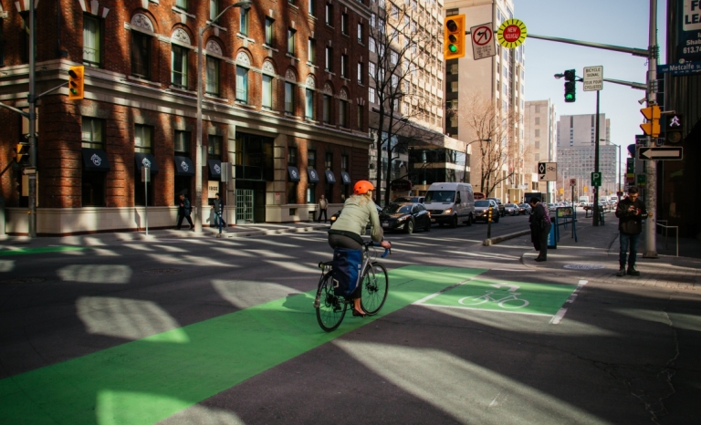 A cyclist travelling in a bike lane on Laurier Ave