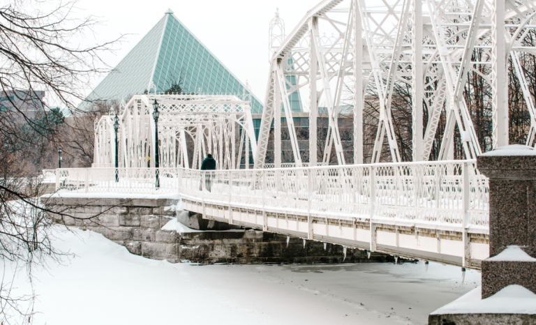 Minto Bridges are steel truss bridges painted white crossing over the Rideau River in New Edinburgh