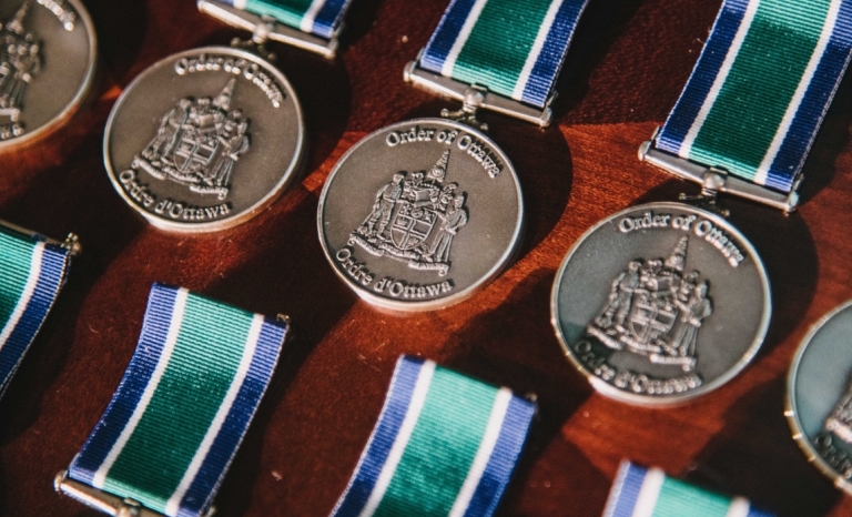 A row of round medallions with the Ottawa Coat of Arms embossed on them.