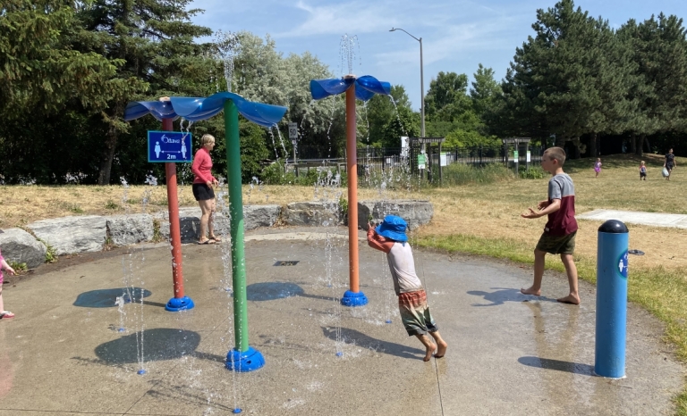 A splash pad with kids playing in the summer