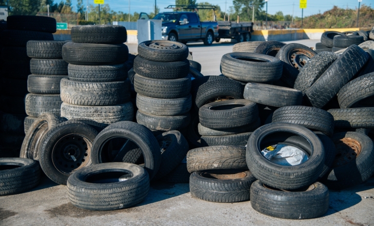 Many stacked piles of used tires