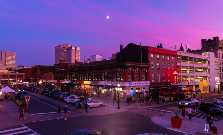 Corner of the Byward Market at dusk wit the moon low in the sky