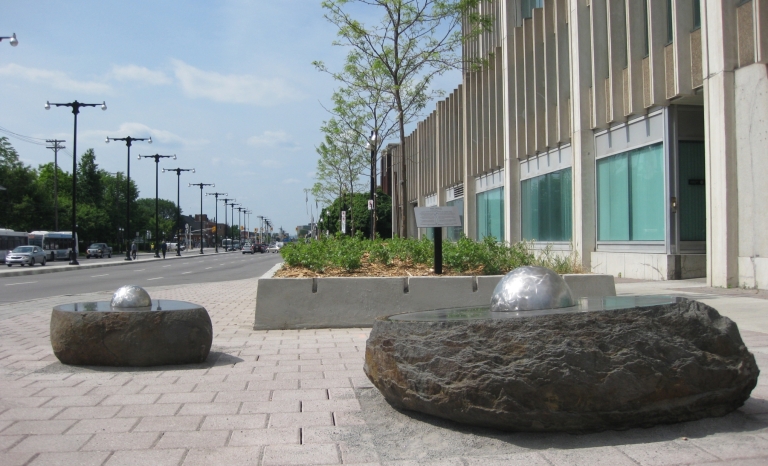 Daytime image of two of the stone and metal sculptures.