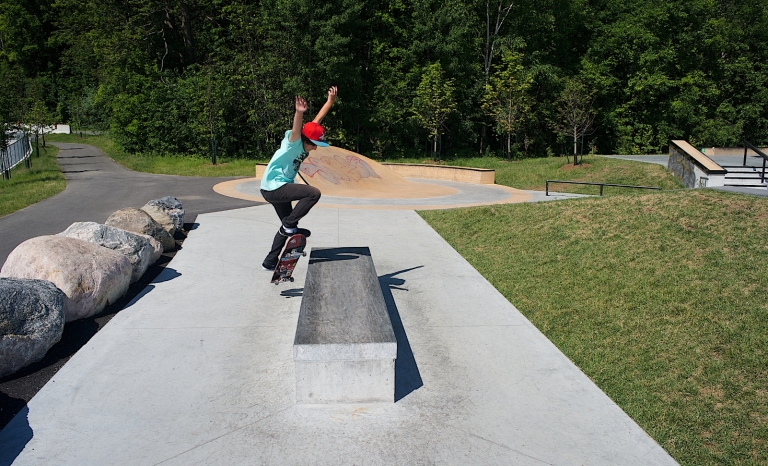 Image of skater doing a trick off the concrete sculpture.