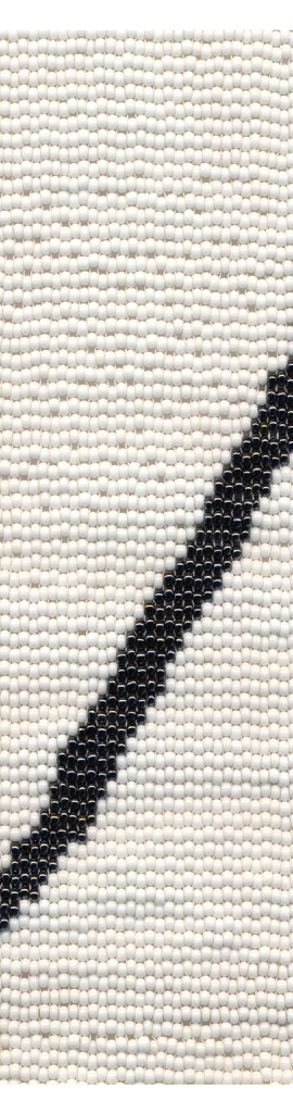 Photograph of a beaded canvas depicting a black scar or slash on a white background.