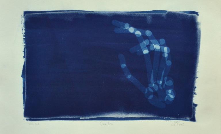 Cyanotype photograph of hand that resembles an x-ray.
