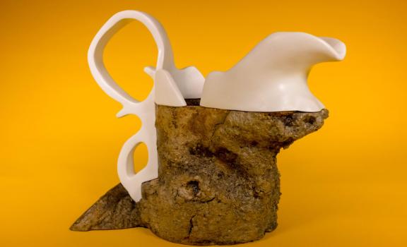 a mixed media sculpture with a yellow background