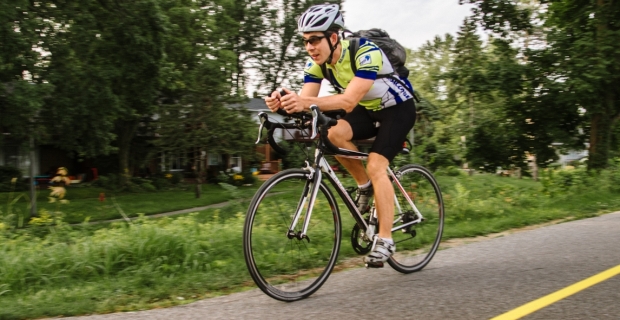 A cyclist with racing gear travelling on a bike path