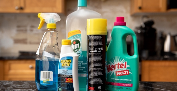 Various household cleaners on a kitchen counter