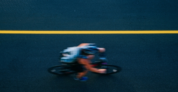 An overhead view of a blurry speeding cyclist on a new bike path