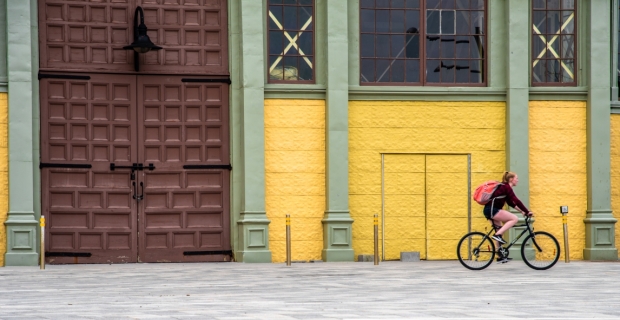 A cyclist riding in front of Aberdeen Pavillion at Lansdowne