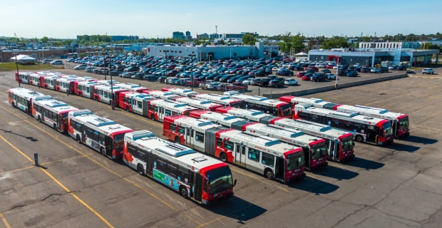 Drone shot of OC Transpo headquarters parking lot with many busses parked in rows