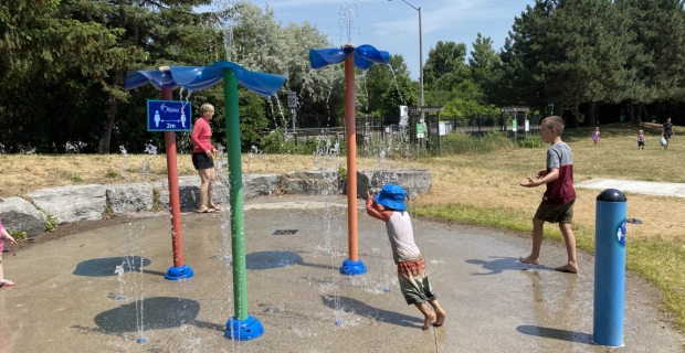 A splash pad with kids playing in the summer